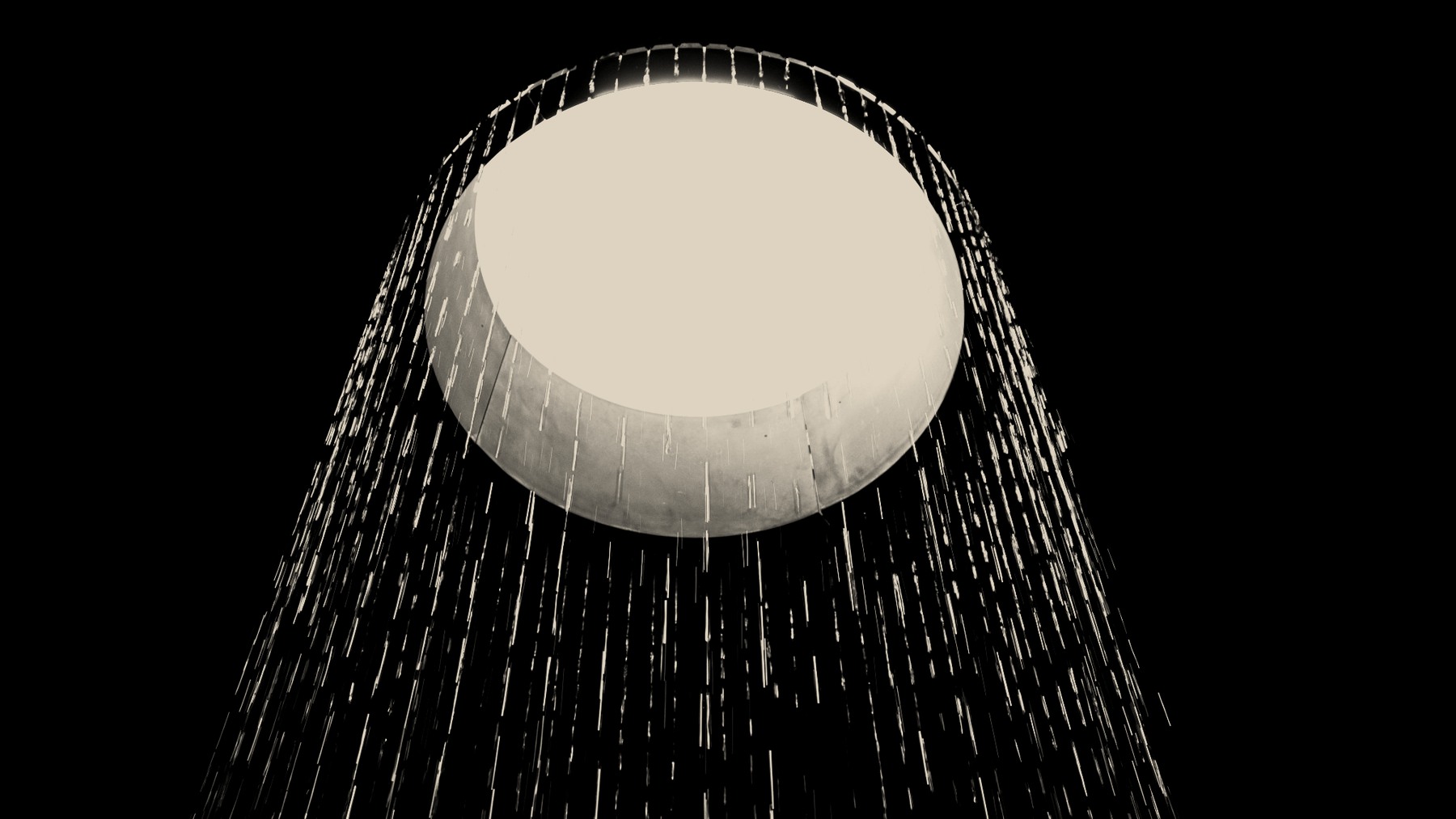 A dark, atmospheric shower scene with falling water from an overhead showerhead.